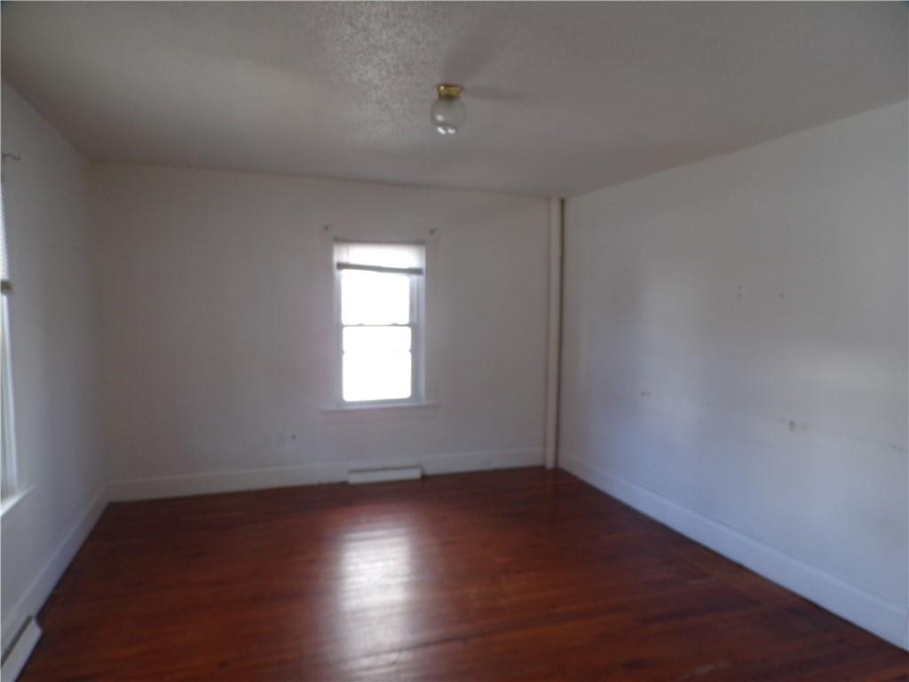 575 Grant Street Indiana, PA 15701 - Photo 6 of 19 an empty room with wooden floor and windows