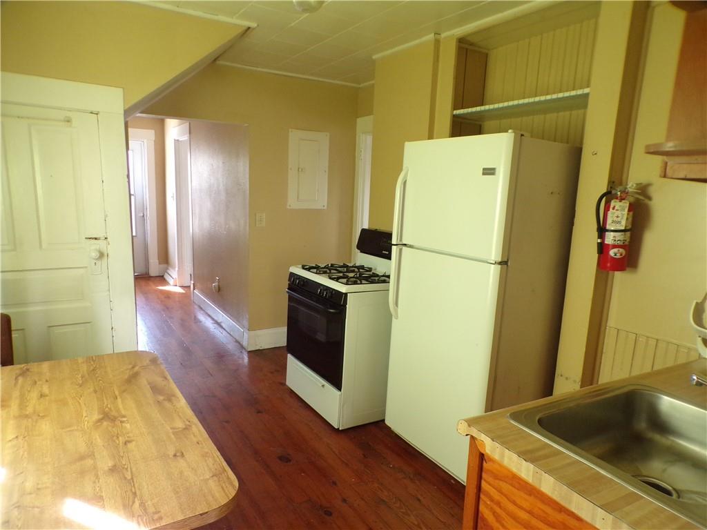 575 Grant Street Indiana, PA 15701 - Photo 8 of 19 a kitchen with a refrigerator sink and wooden floor
