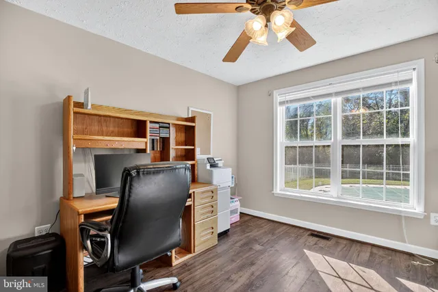 a livingroom with workspace and a window
