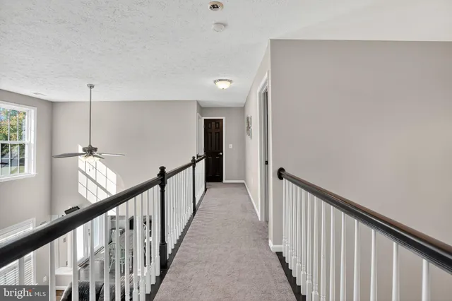 a view of a hallway with stairs