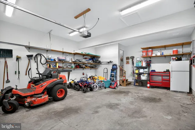 a view of parking garage with cars and other equipment