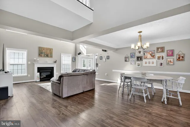 a living room with furniture a fireplace and kitchen view