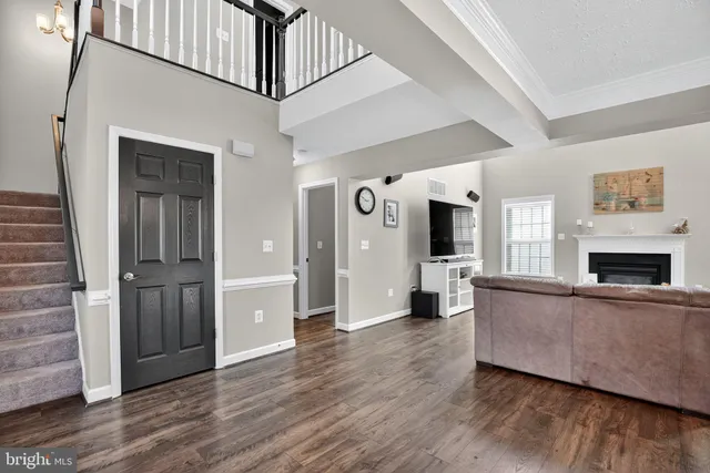 a view of a livingroom with wooden floor and fireplace