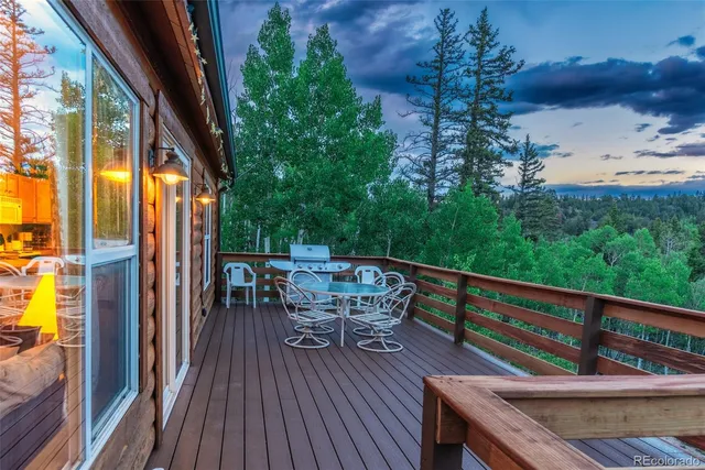 a view of a balcony with furniture and wooden floor