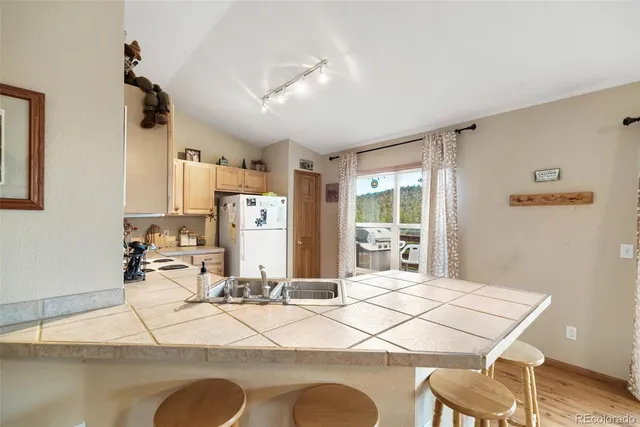 a view of a kitchen with workspace and windows