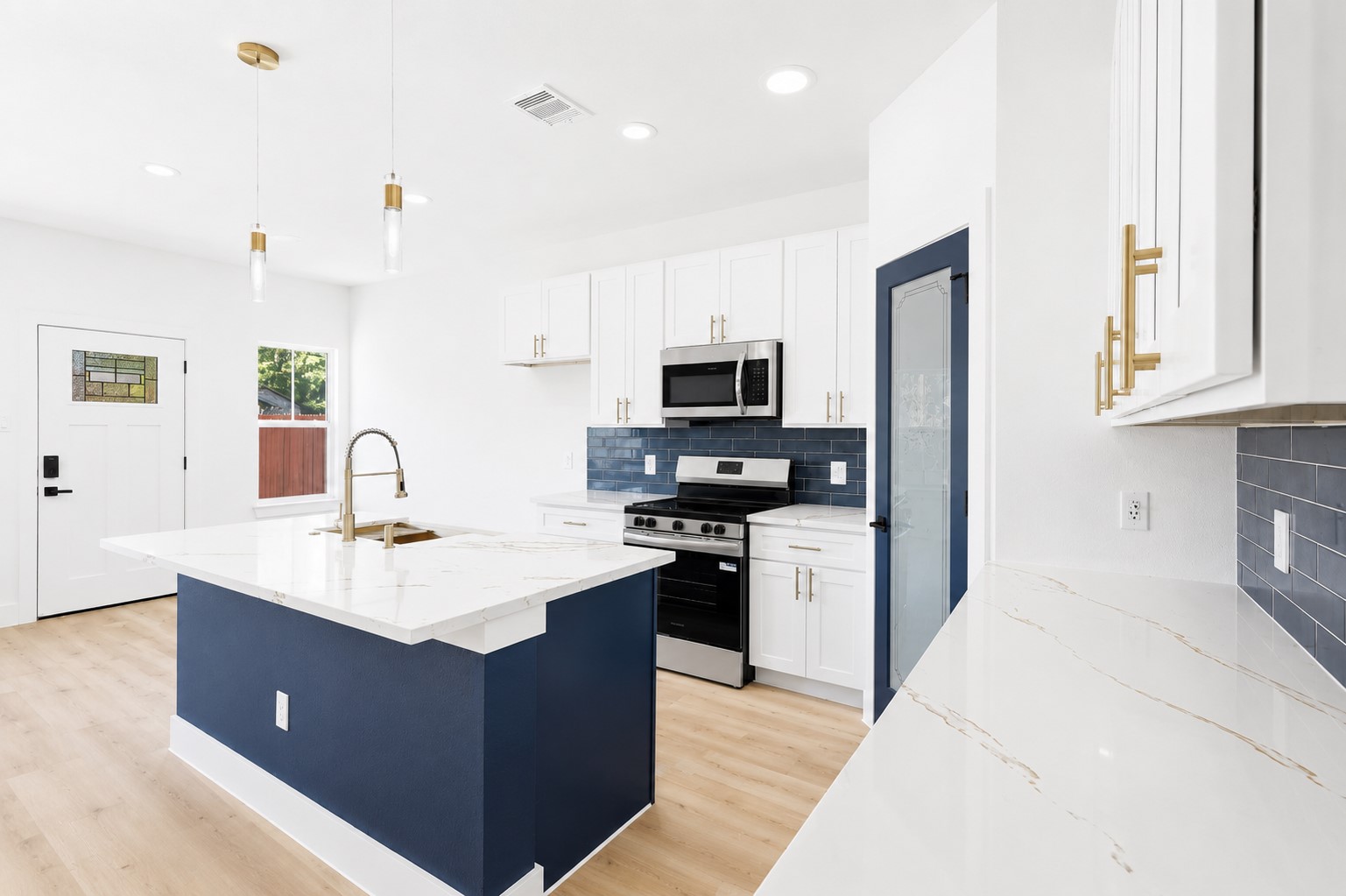 4606 Mallow Street, Unit A Houston, TX 77051 - Photo 7 of 21 a large kitchen with stainless steel appliances granite countertop a stove top oven a sink dishwasher and a refrigerator with wooden floor