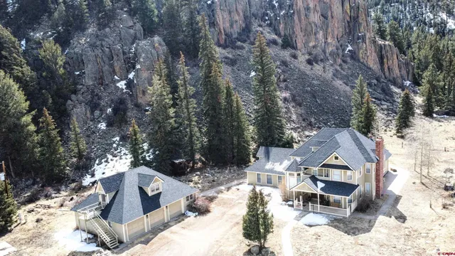 a view of a house with a yard covered in snow