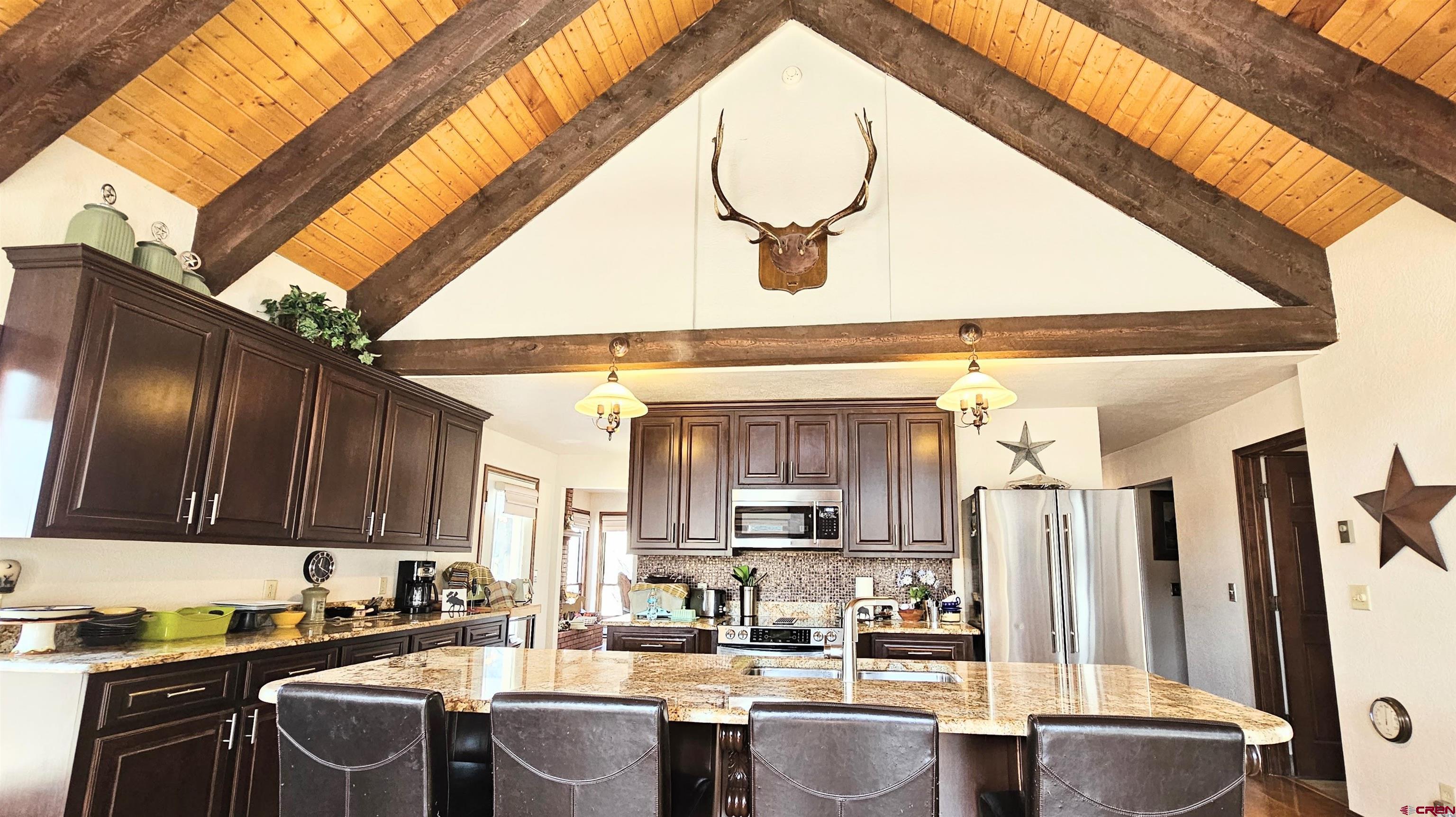 Undisclosed Beaver Creek Road South Fork, CO 81154 - Photo 13 of 26 a kitchen with stainless steel appliances granite countertop a sink a stove and a microwave