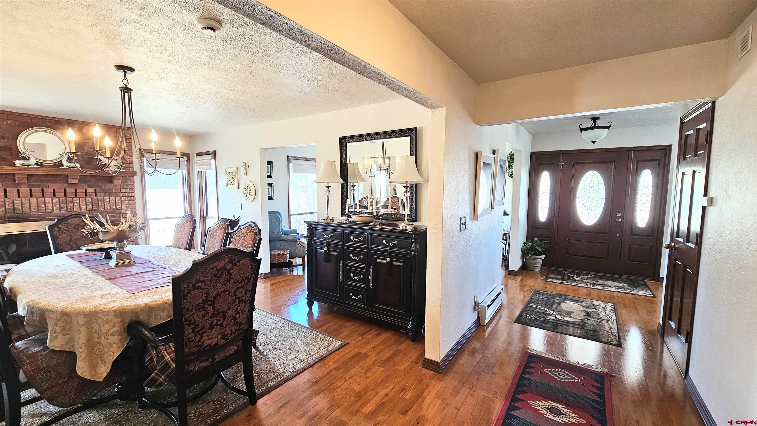 Undisclosed Beaver Creek Road South Fork, CO 81154 - Photo 14 of 26 a view of a dining room with furniture and wooden floor