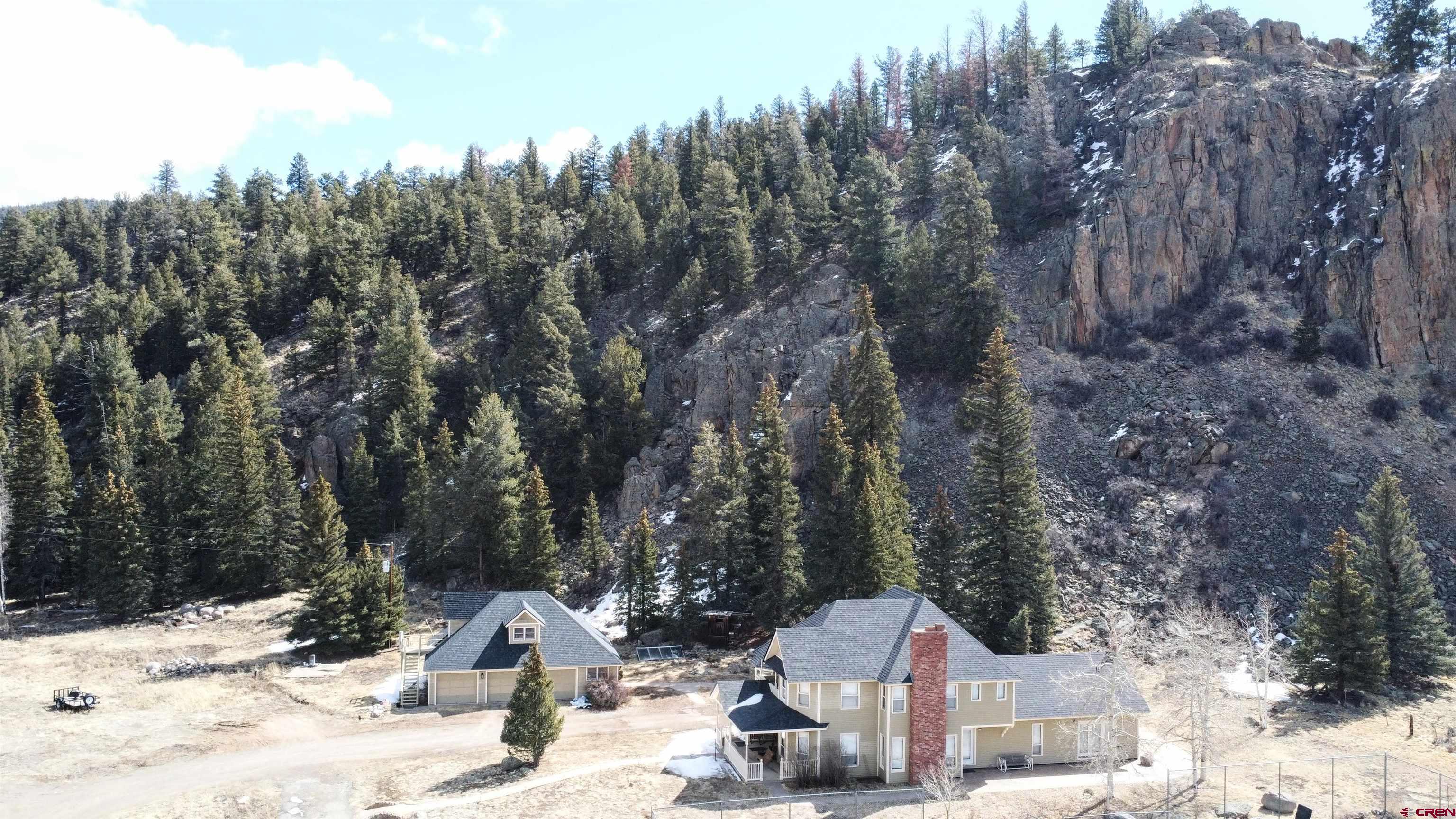 202 County Road 20 South Fork, CO 81154 - Photo 2 of 26 a pathway of a house with snow on the road