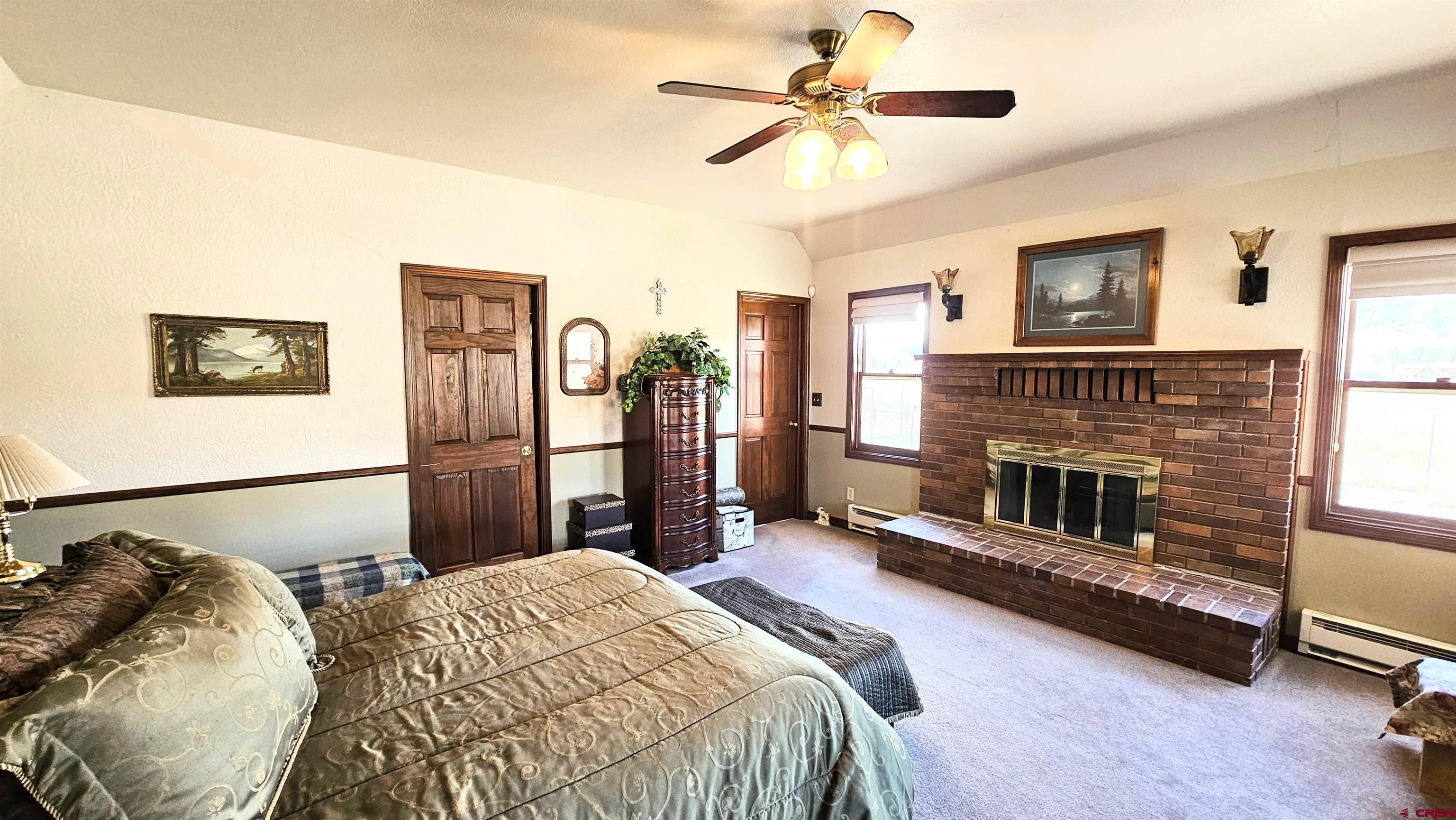 202 County Road 20 South Fork, CO 81154 - Photo 4 of 26 a bed room with a bed and a fireplace