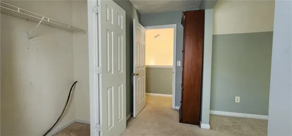 an empty room with windows and closet