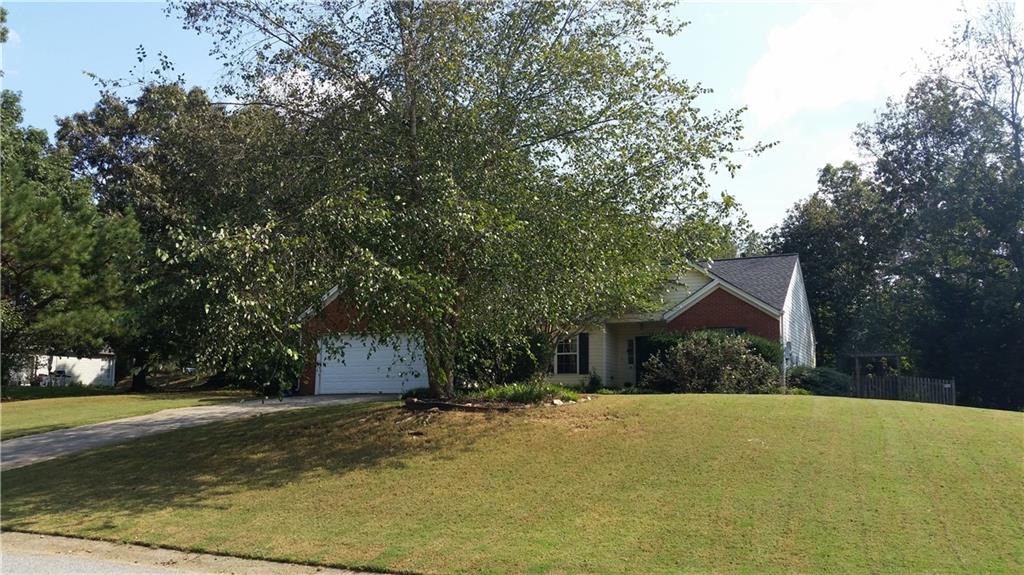 4120 Ridgebrook Bend Cumming, GA 30028 - Photo 1 of 1 a front view of a house with a yard and garage