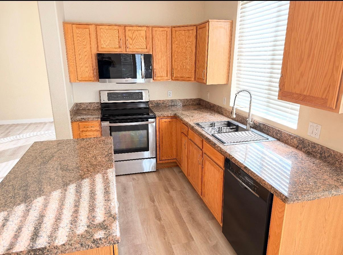 17640 North 17th Street Phoenix, AZ 85022 - Photo 6 of 21 a kitchen with granite countertop a sink and a stove top oven