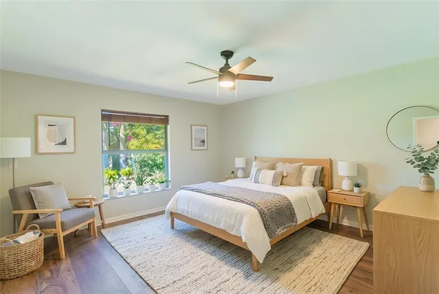 a bedroom with a large bed chandelier and a window