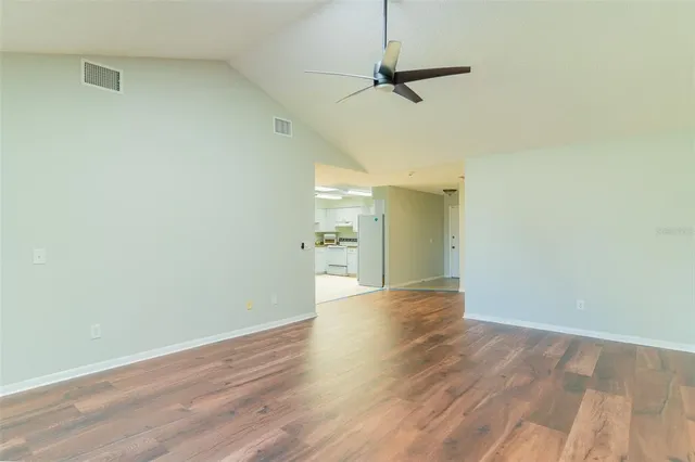a view of empty room with wooden floor