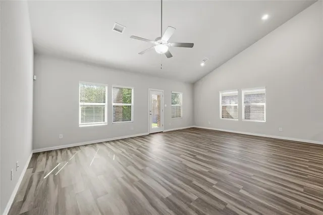 wooden floor in an empty room with a window