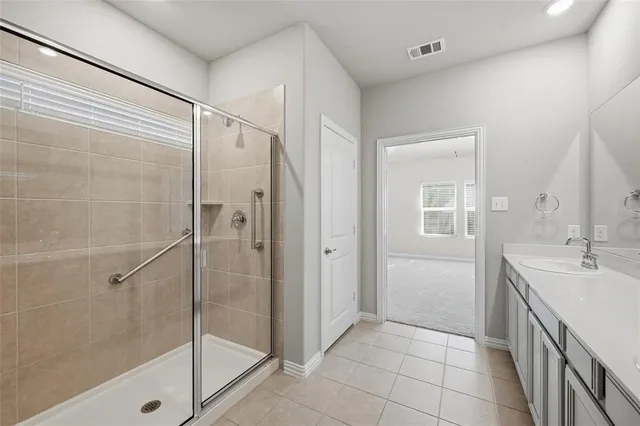 a bathroom with a shower sink and mirror