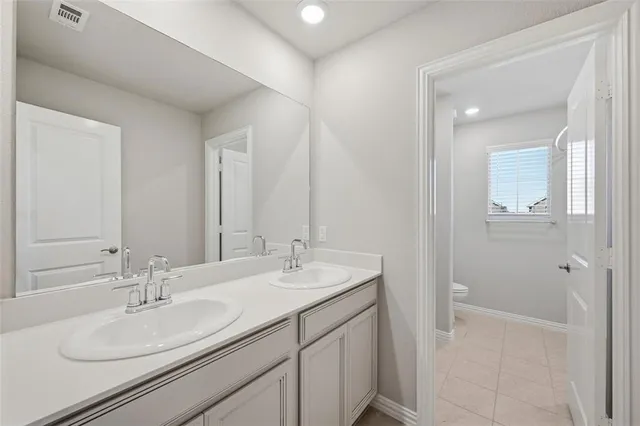 a bathroom with a sink double vanity and a mirror