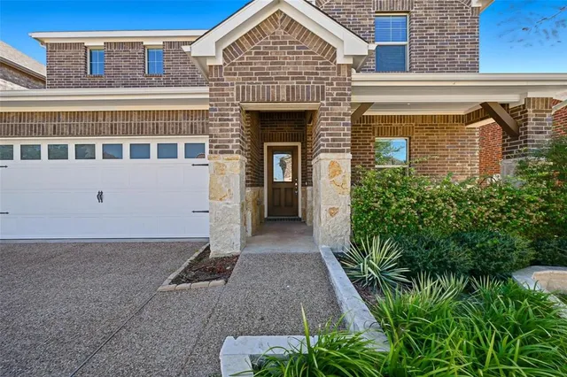 a view of a house with potted plants