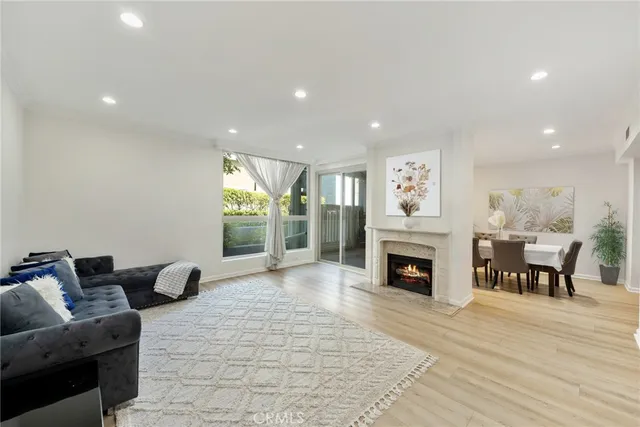 a living room with furniture large window and a fireplace