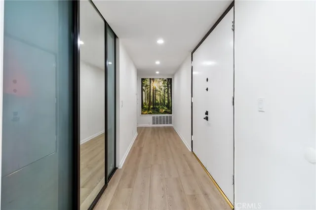 a view of a hallway with wooden floor