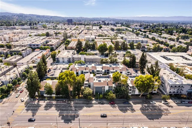 an aerial view of a building with streets and trees