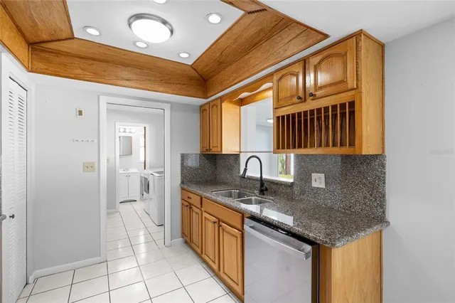 a kitchen with stainless steel appliances granite countertop a sink and cabinets