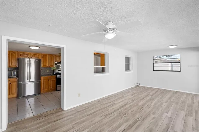 a view of empty room with wooden floor