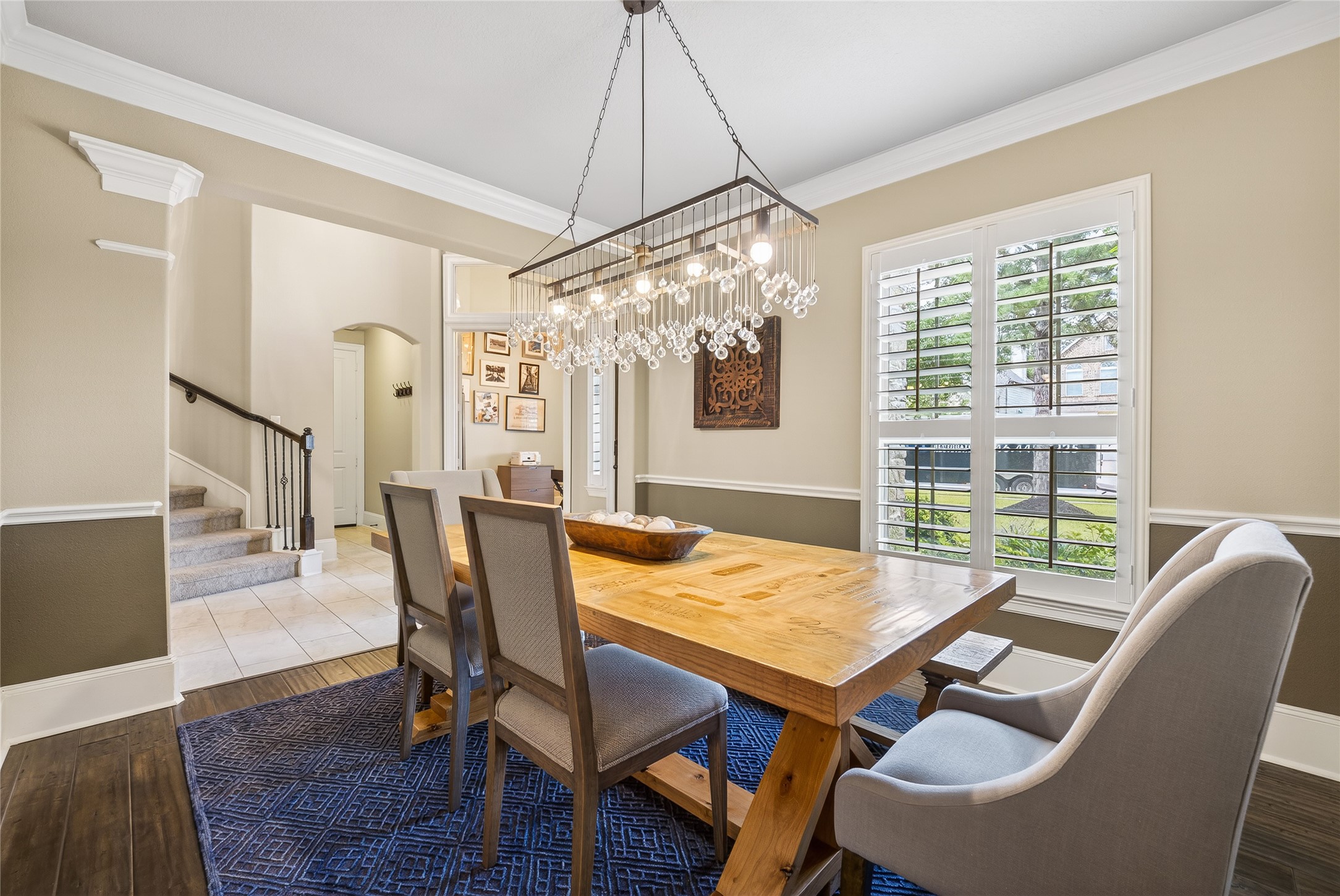 7907 Augusta Creek Court Spring, TX 77389 - Photo 11 of 49 This dining room features a warm, inviting atmosphere and a modern chandelier. Natural light floods through plantation shutters, enhancing the neutral color palette.