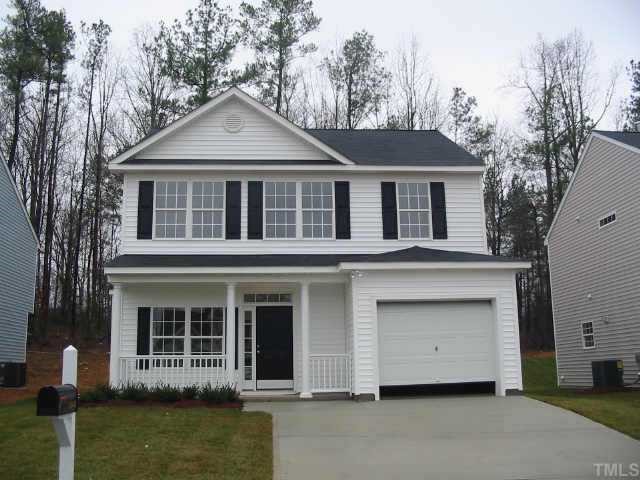 5848 Wynmore Road Raleigh, NC 27610 - Photo 1 of 1 a front view of a house with a yard and garage