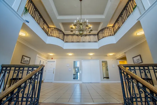 a view of a hallway with wooden floor and stairs