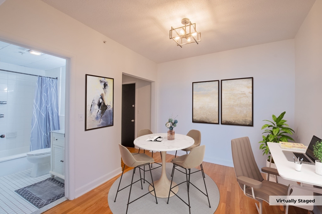285 Lynn Shore Drive, Unit 710 Lynn, MA 01902 - Photo 4 of 26 a view of a dining room with furniture and wooden floor