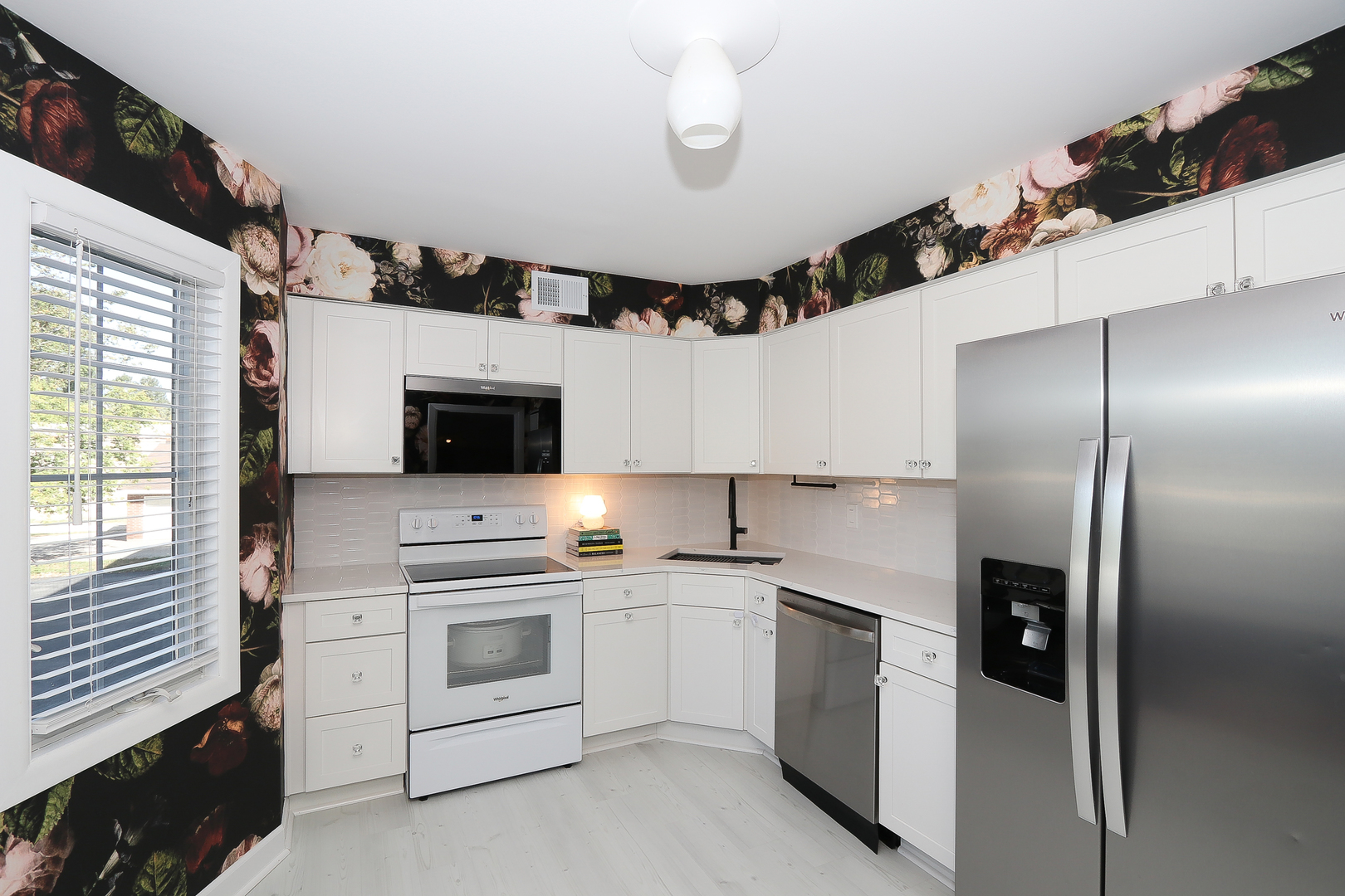 715 Ridge Road, Unit 2E Wilmette, IL 60091 - Photo 13 of 24 a kitchen with cabinets stainless steel appliances and window