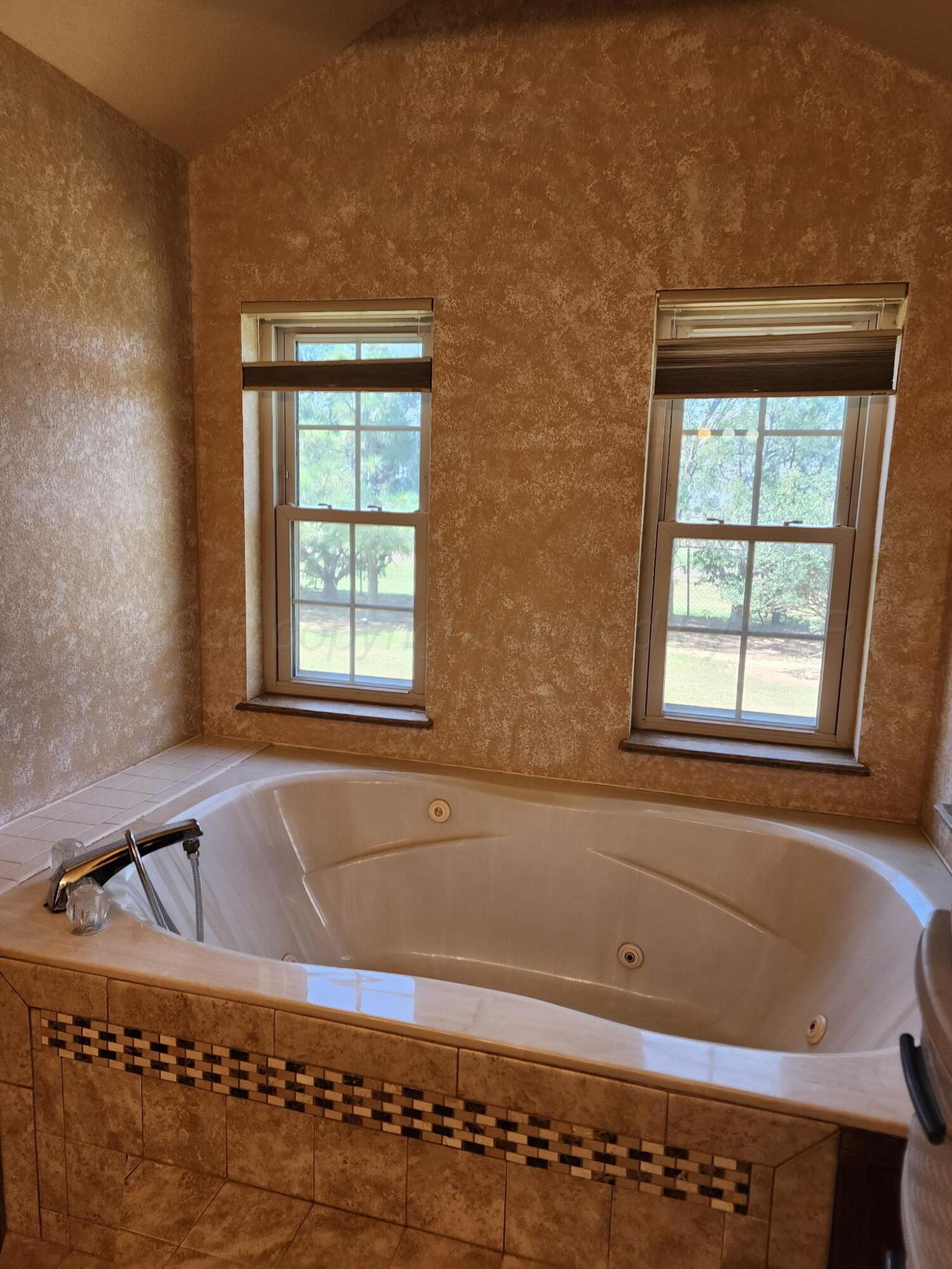 16700 Old Ranch Road Canyon, TX 79015 - Photo 26 of 54 a bathroom with a bathtub and window