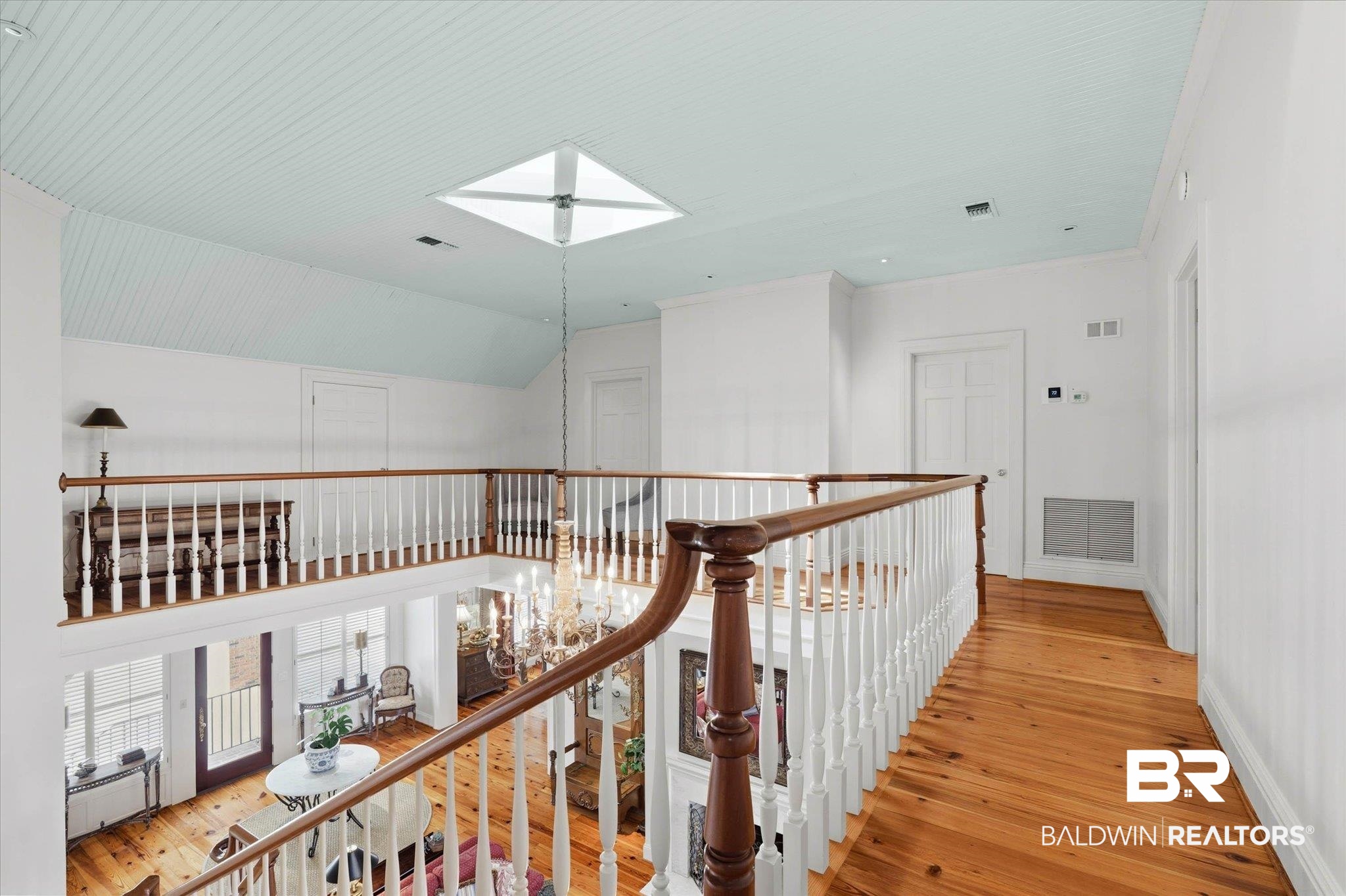 3500 Higgins Road Mobile, AL 36619 - Photo 28 of 54 Hallway with light wood-style flooring, a skylight, vaulted ceiling, and crown molding