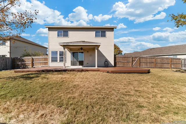 a view of a house with wooden floor and a fence