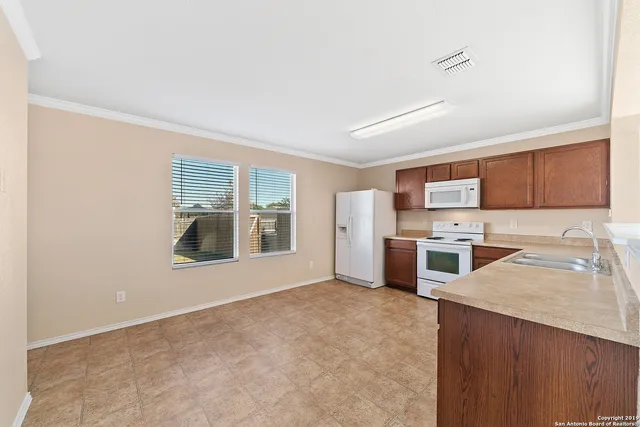 a view of a kitchen with a sink stove and cabinets
