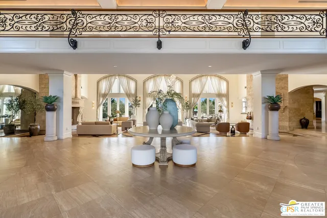 a living room with fireplace furniture and a large window