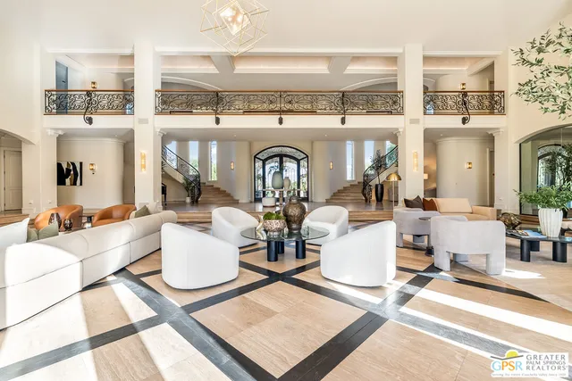 a living room with stainless steel appliances kitchen island granite countertop a stove a sink a refrigerator and a dining table with garden view