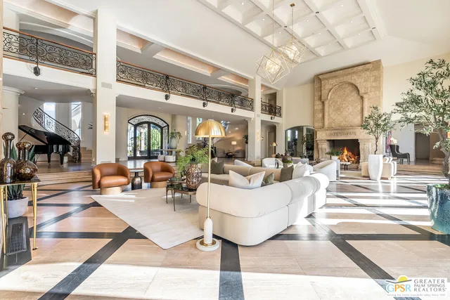 a large white kitchen with lots of counter top space and chandelier