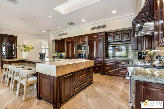 a living room with fireplace furniture and a large window