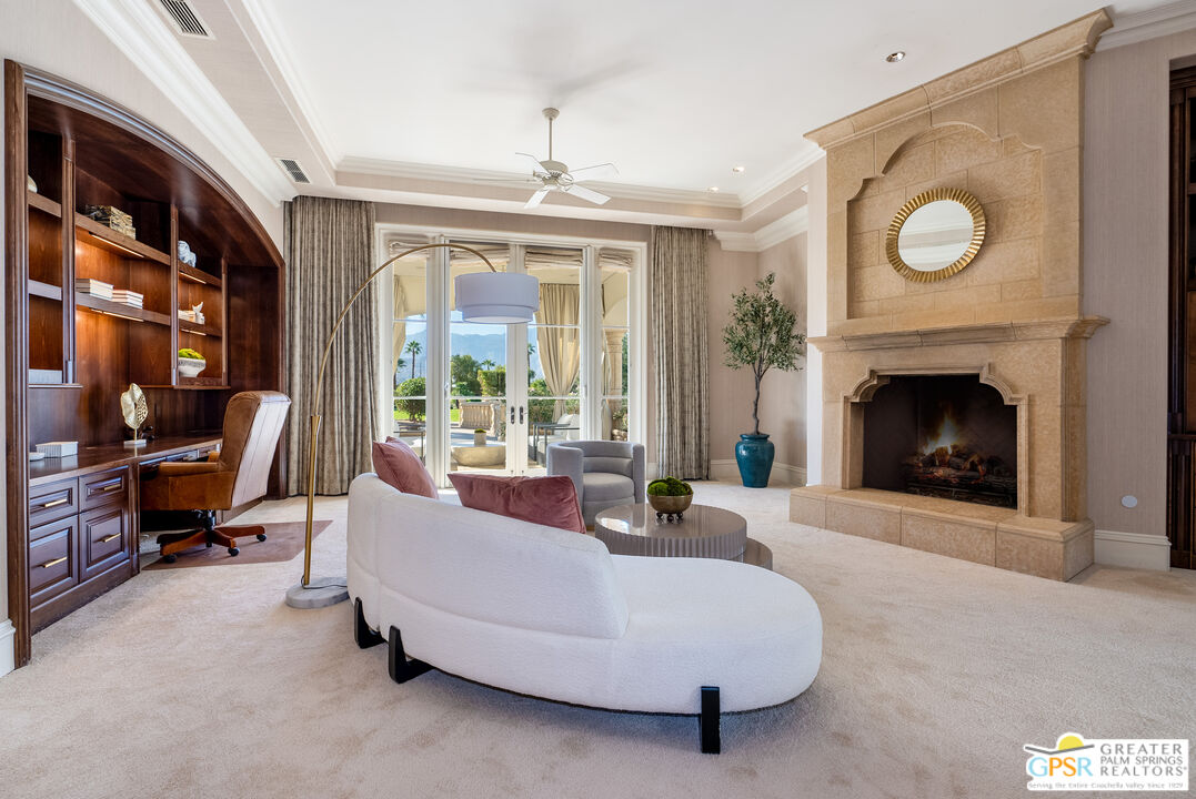 1 St Petersburg Court Rancho Mirage, CA 92270 - Photo 30 of 73 a living room with furniture and a fireplace