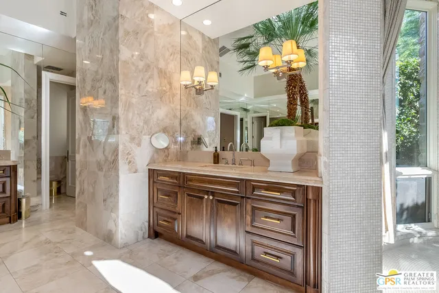 a living room with fireplace furniture and a chandelier