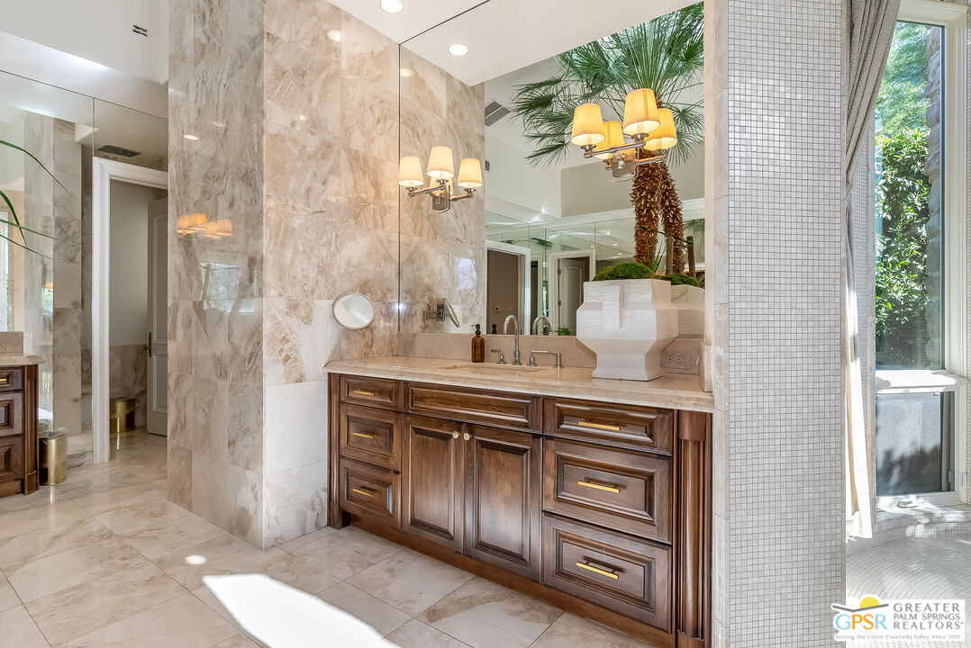 1 St Petersburg Court Rancho Mirage, CA 92270 - Photo 35 of 73 a bathroom with a sink a vanity and a large mirror
