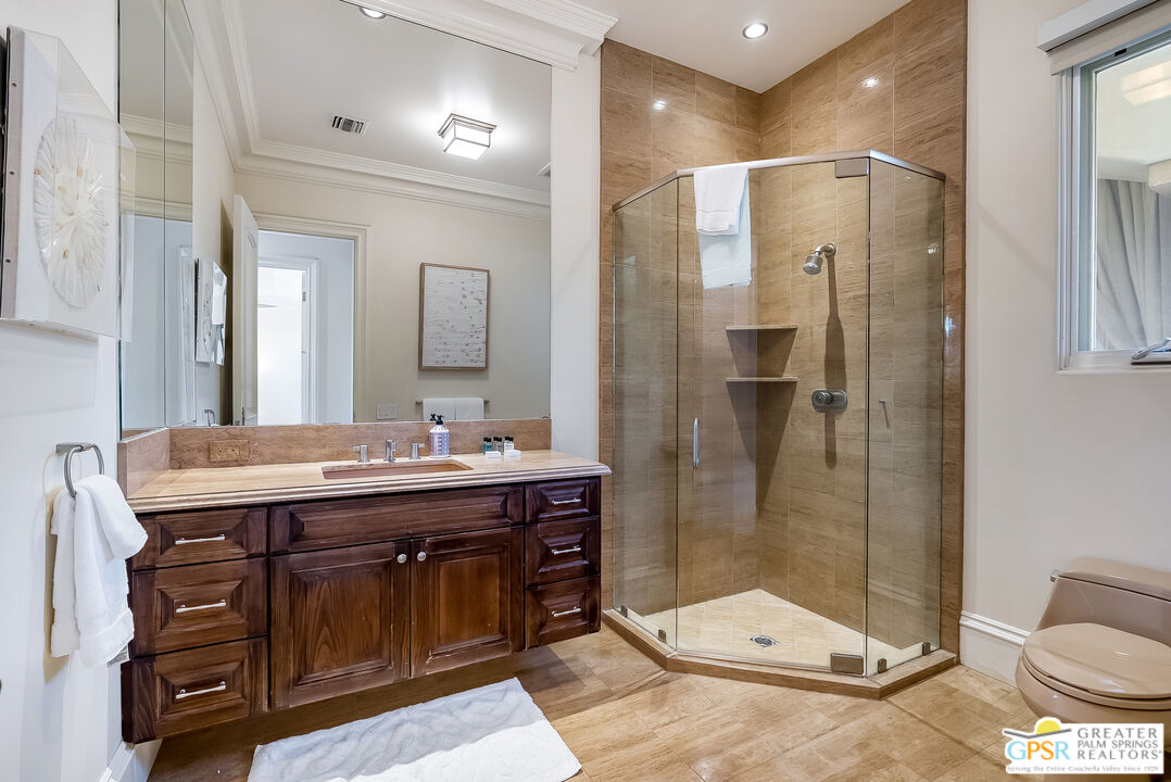 1 St Petersburg Court Rancho Mirage, CA 92270 - Photo 66 of 73 a bathroom with a granite countertop sink toilet and shower