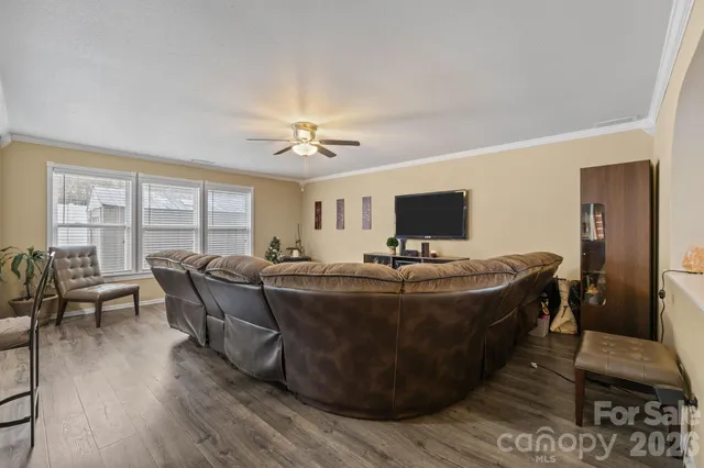 a bed room with furniture and a large window