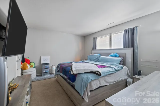 a bedroom with bed and window