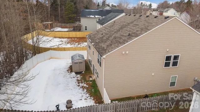 a aerial view of a yard with a table and chairs under an umbrella