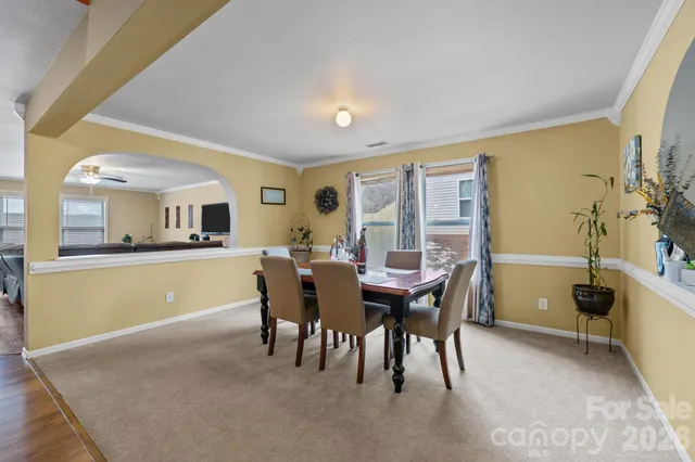 a dining room with furniture and window